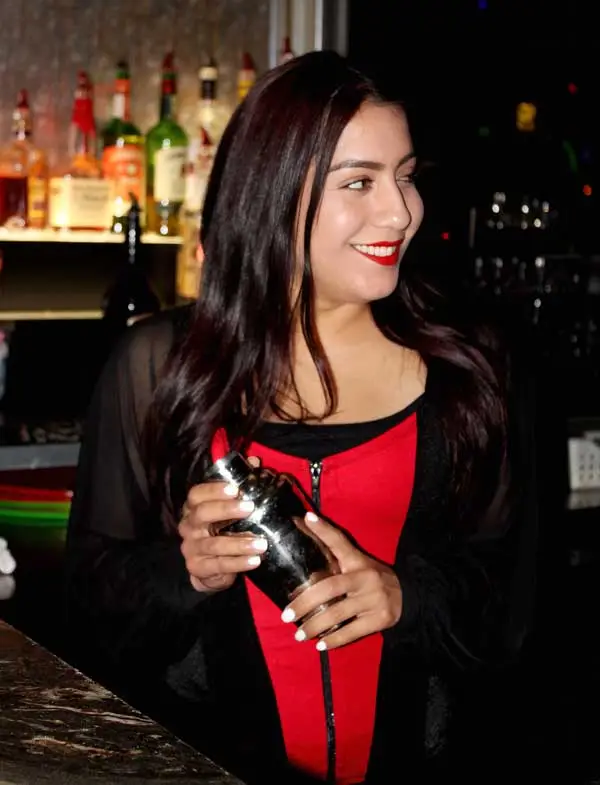 Club 390 bartender Danielle posing with a martini shaker.